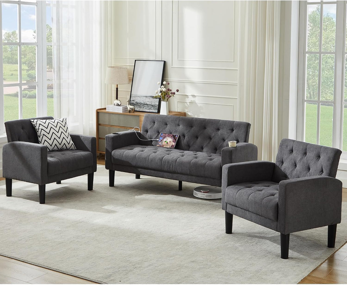 Charcoal gray loveseat and two armchairs with a charging cable on the loveseat and a robot vacuum under it