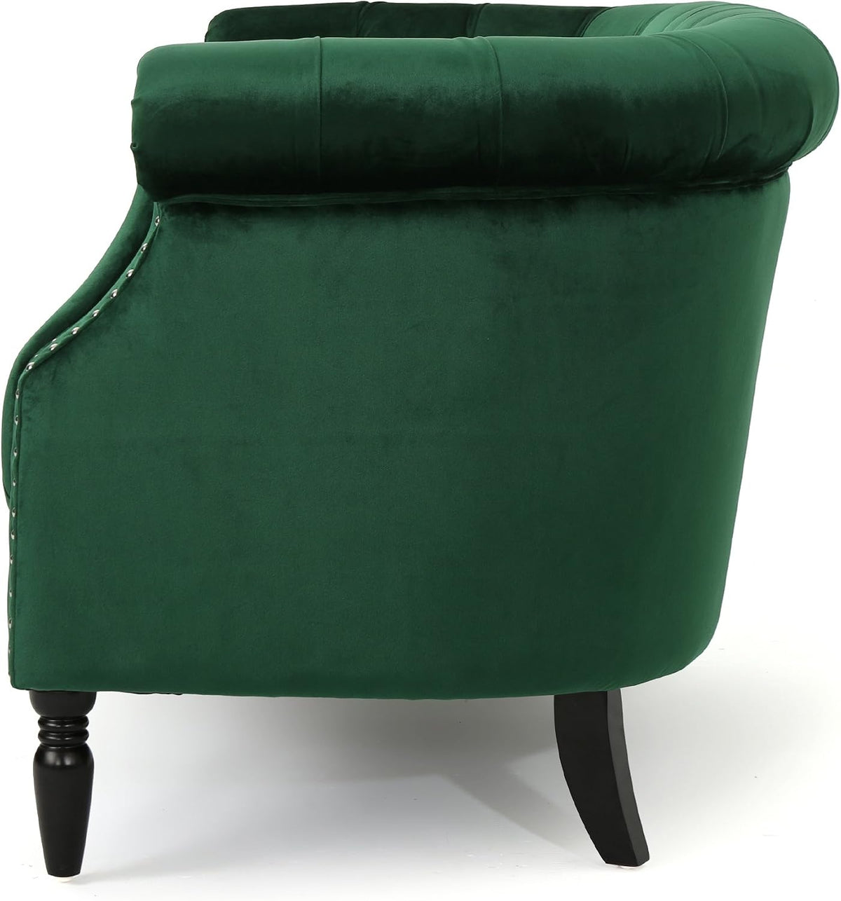 Side profile of emerald velvet loveseat showing rolled back, scrolled arm and two dark turned legs