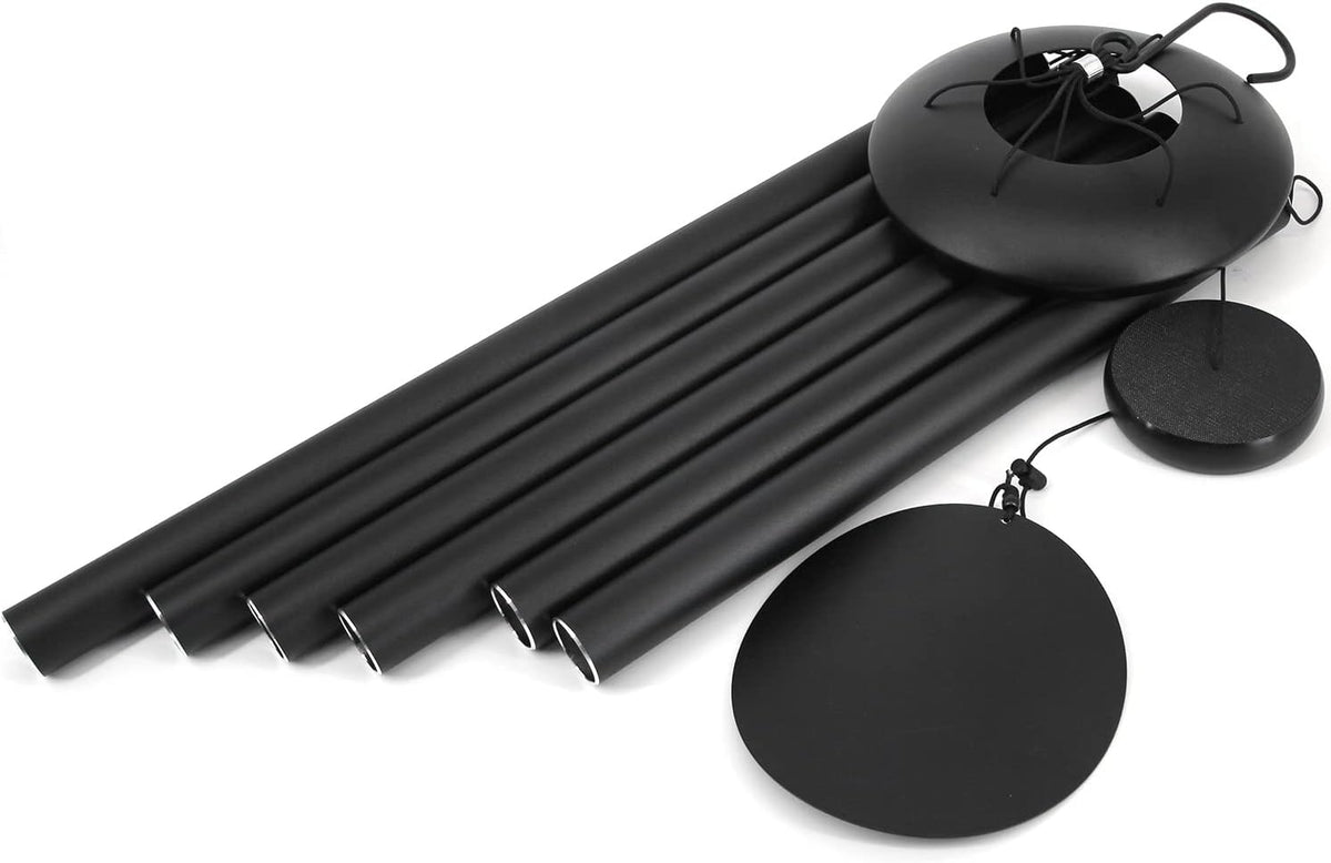 Disassembled black wind chime showing six tubes, round windcatcher and domed top on white background