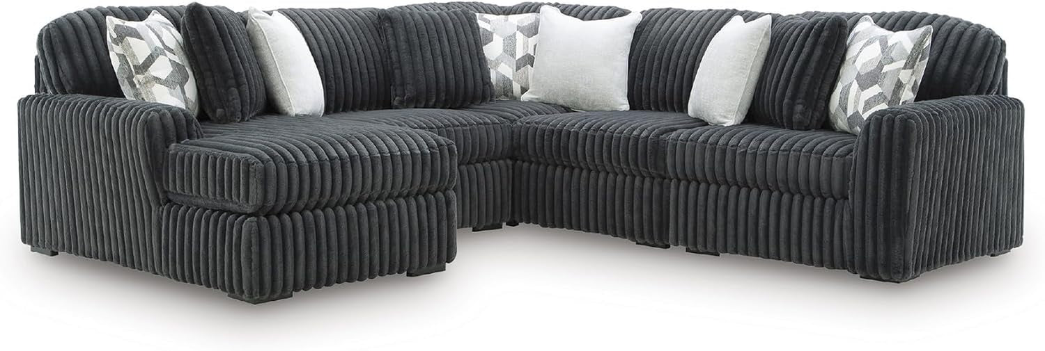 Wide view of a deep L-shaped sectional with ribbed upholstery and assorted throw pillows.