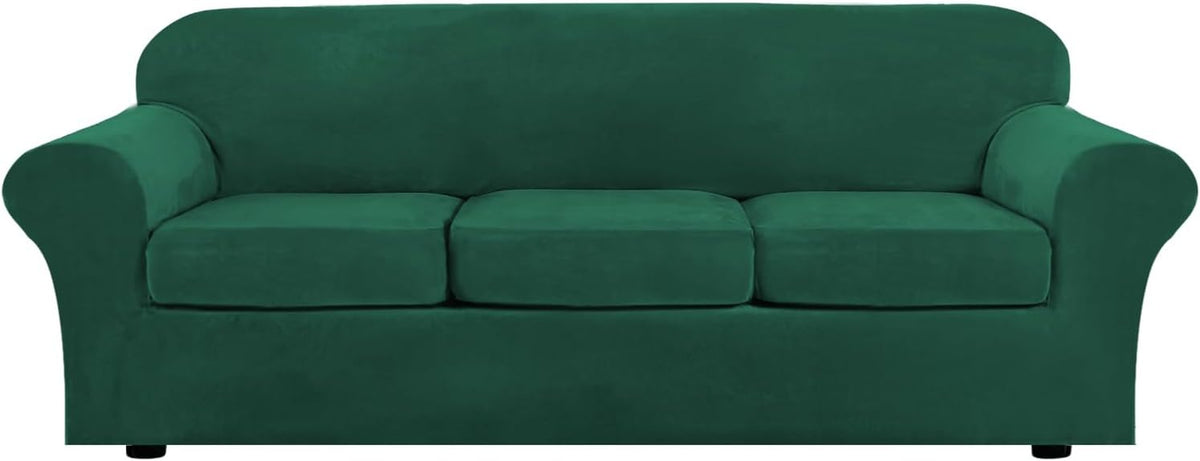Deep emerald green three-seat sofa on white background with smooth fitted slipcover and seat seam lines.