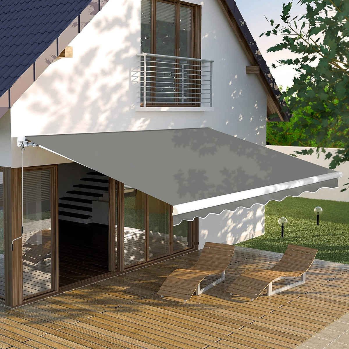 Gray manual retractable awning extended over a wooden deck with two lounge chairs.