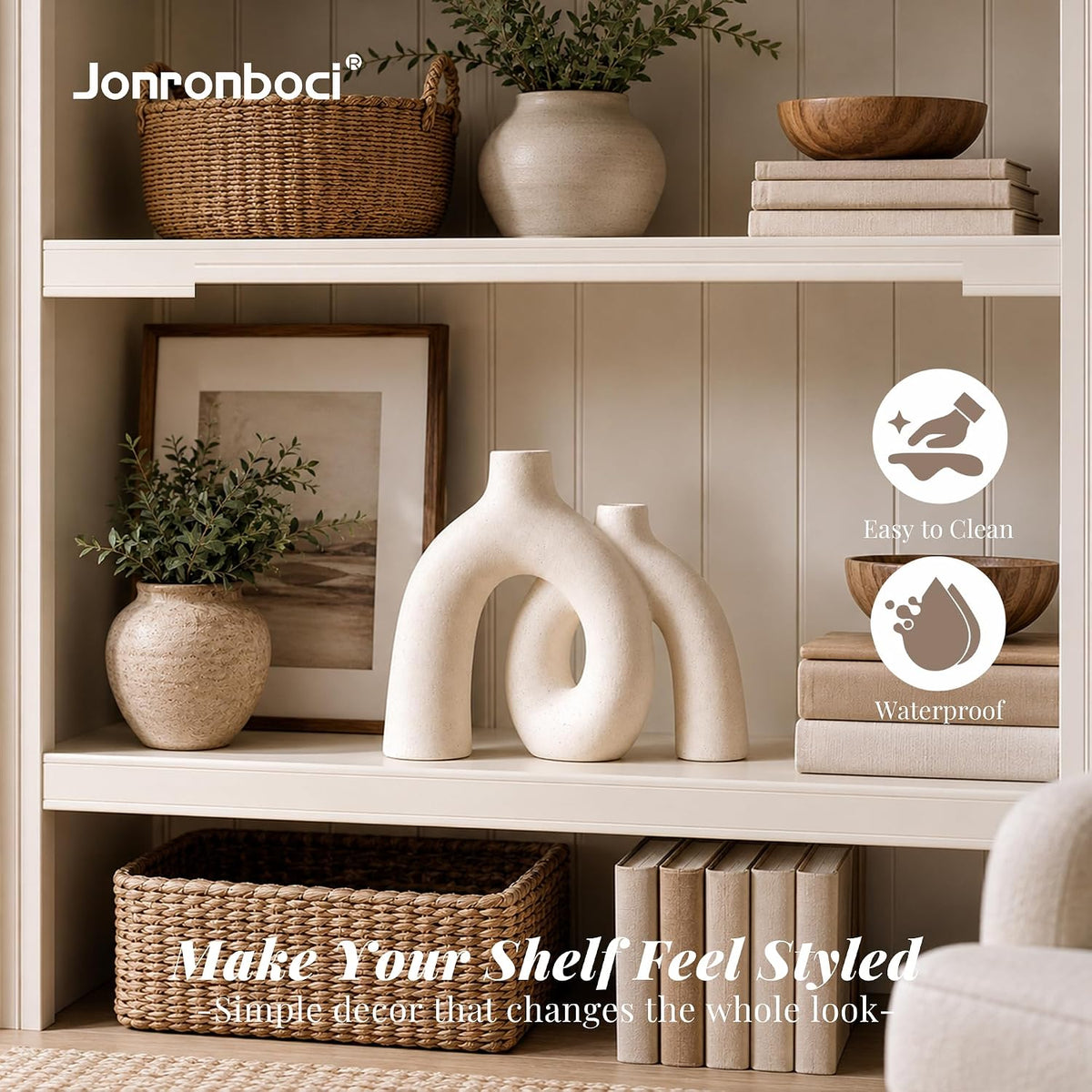 Pair of cream ceramic donut vases displayed together on a neutral-toned shelf with woven basket and books