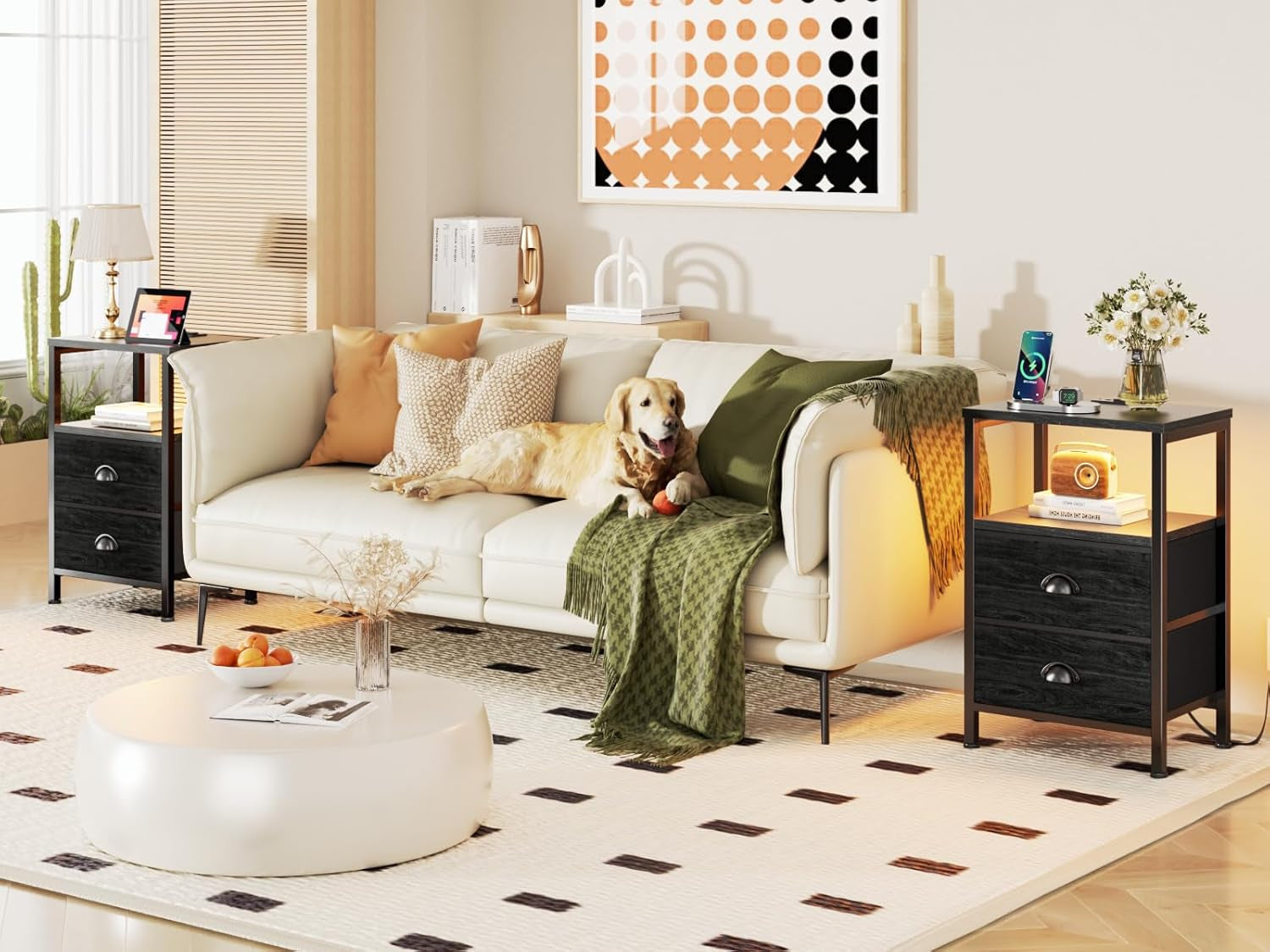 Living room scene with a white sofa and two black nightstands flanking it, one with warm shelf lighting