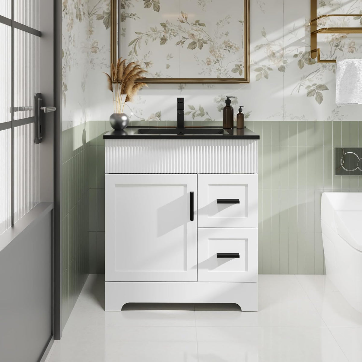 Front view of a compact white single-sink vanity with black countertop and vertical paneling detail.