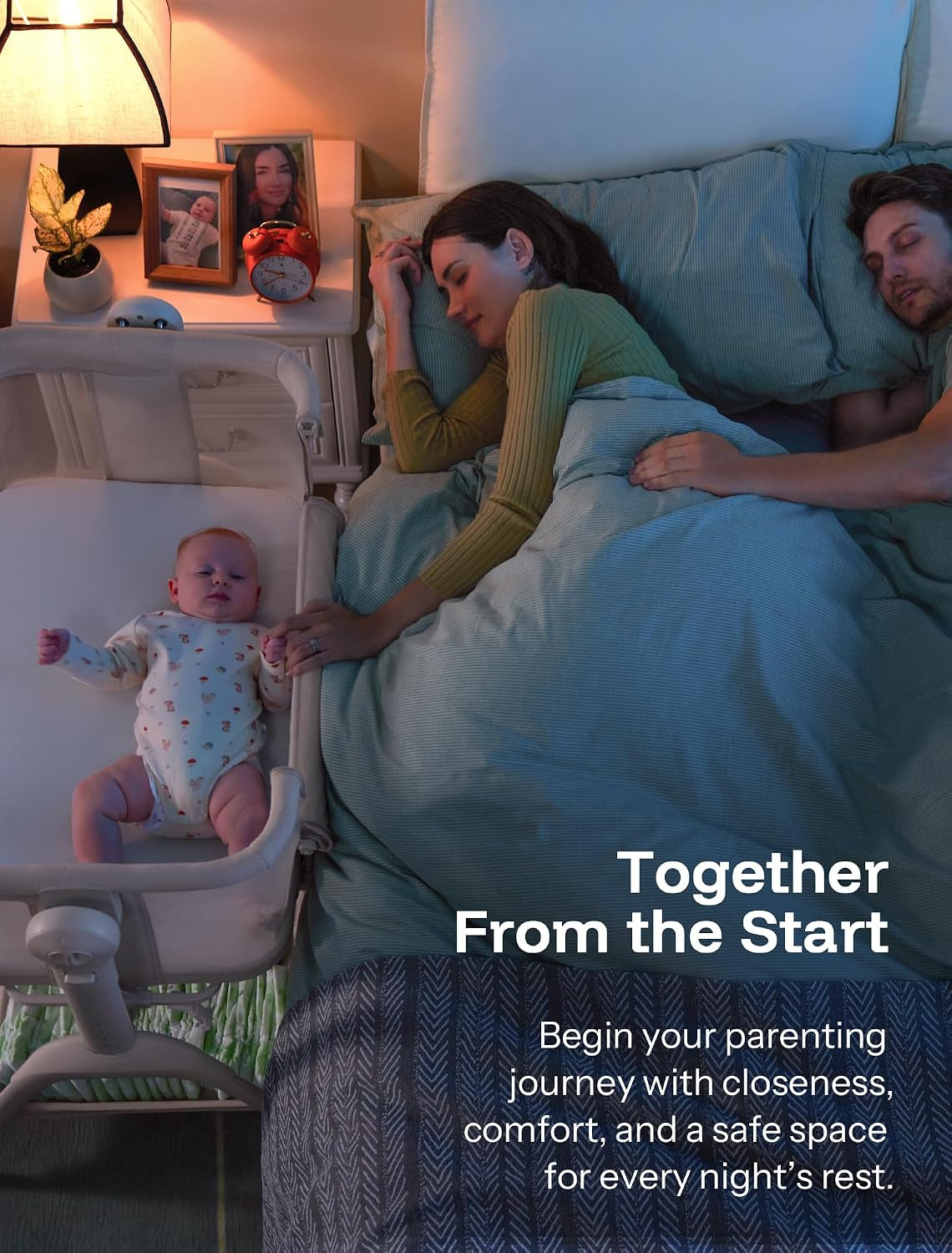Sleeping parents in bed beside a bassinet with a baby lying awake inside at night.