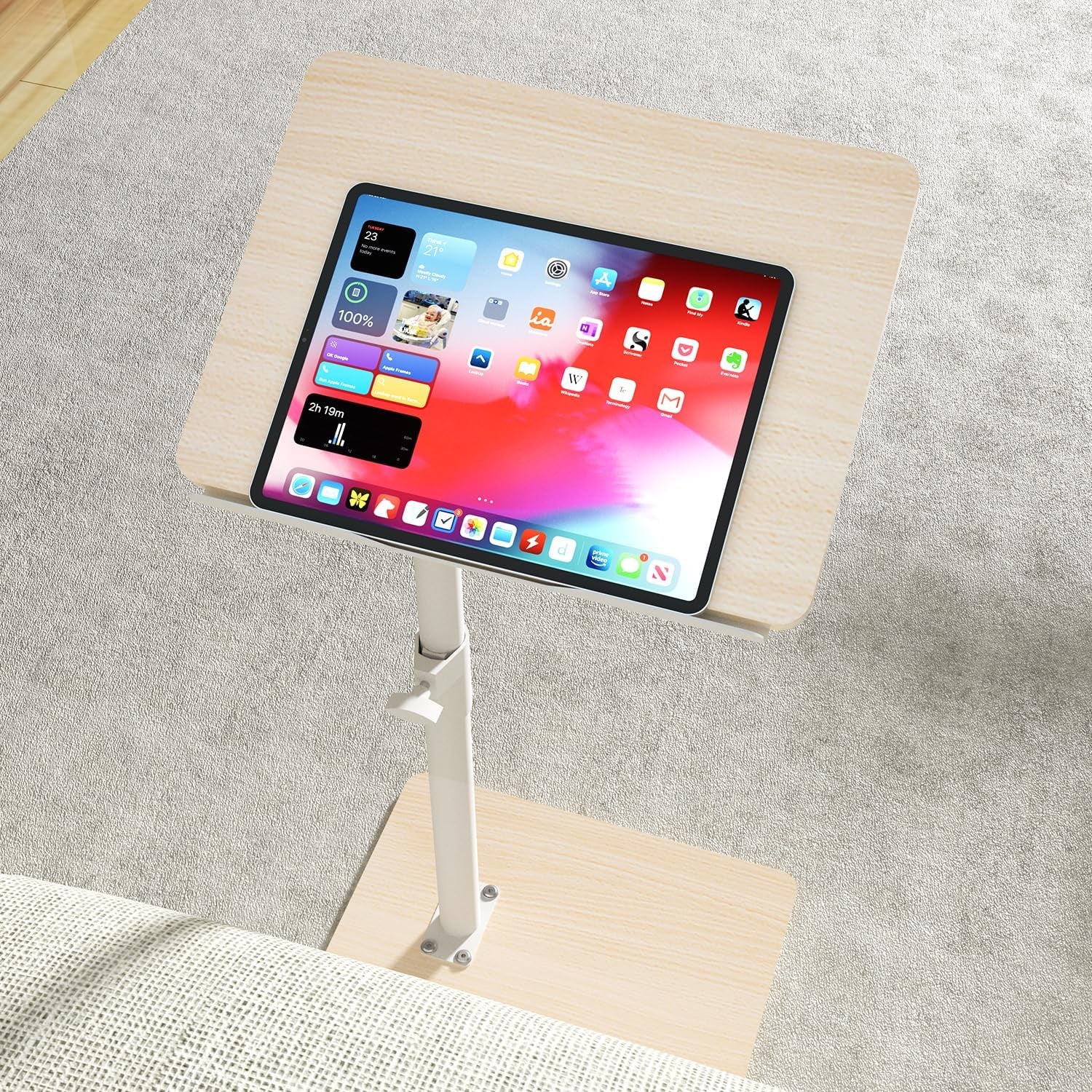 Light wood rectangular tray table top holding a tablet in the built-in slot, angled view over carpet