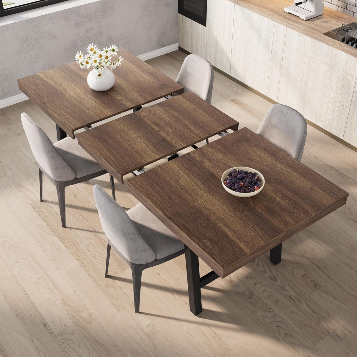 Overhead angle of the table mid-extension in a dark finish showing the central folded leaf and metal slides.