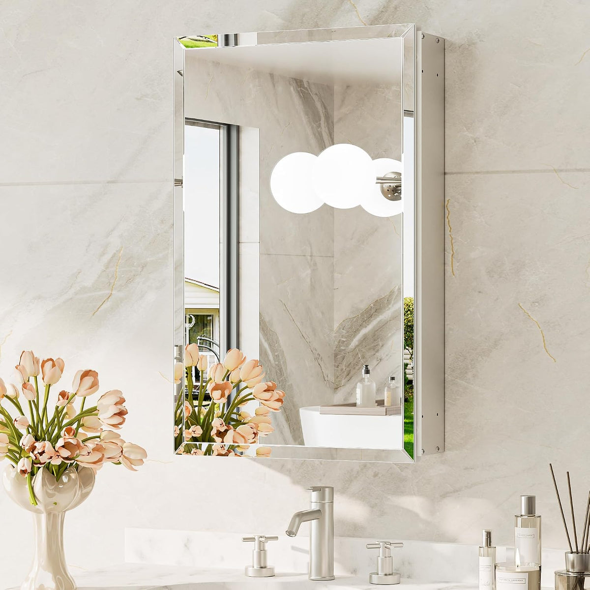 Silver beveled mirror medicine cabinet mounted above a sink, angled front view with floral decor