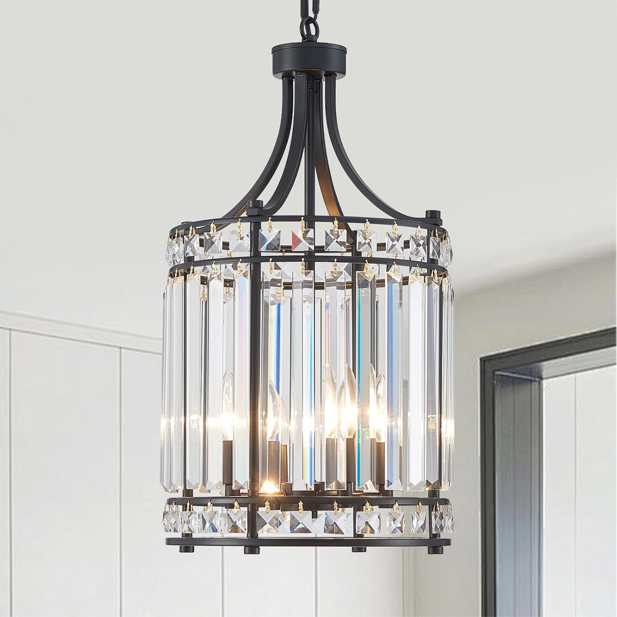 Close-up of the black-finish pendant showing inner candelabra bulbs behind vertical rectangular crystal bars.