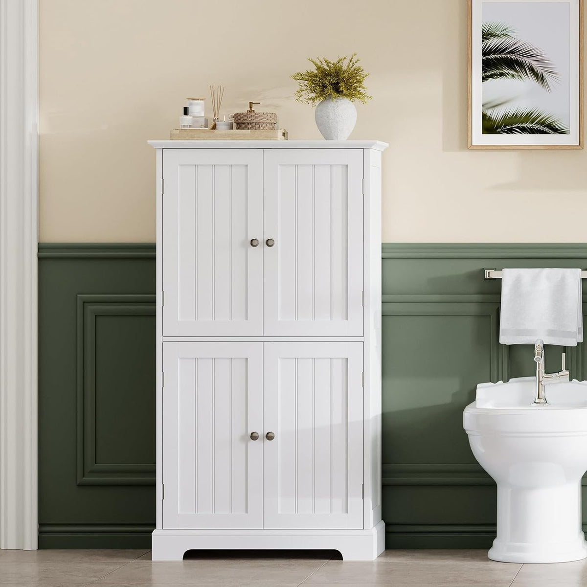 Close front view of the white 4-door cabinet showing metal knob handles and beadboard-style doors
