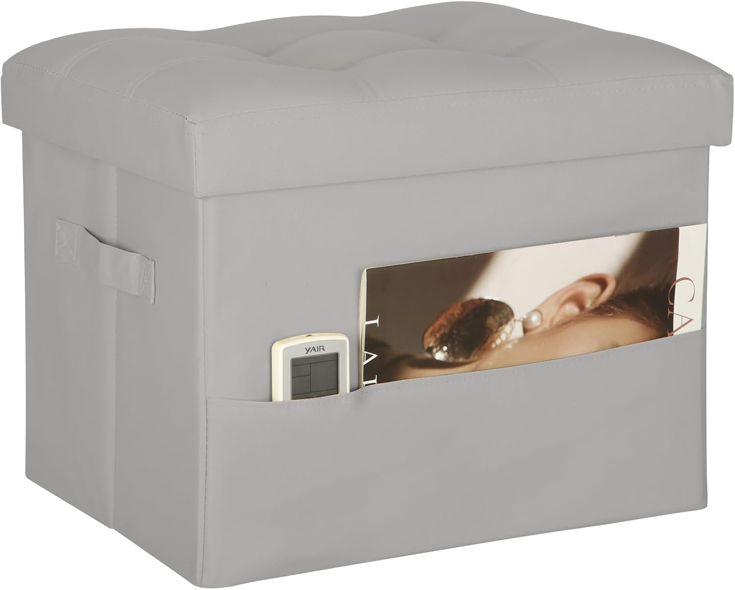 Gray PU storage ottoman with side pocket holding a remote and magazine, lid closed.