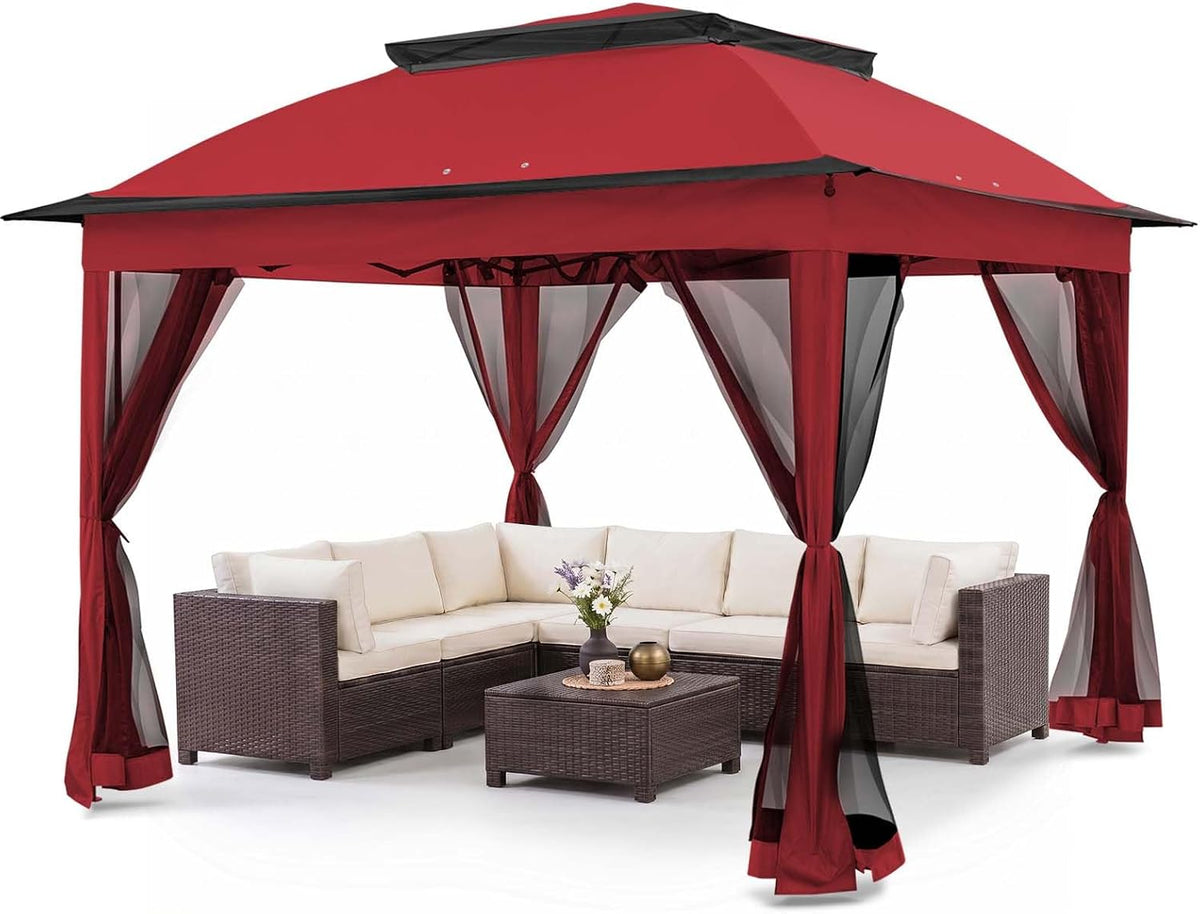 Red pop-up gazebo with tied-back mesh curtains over patio sectional and coffee table