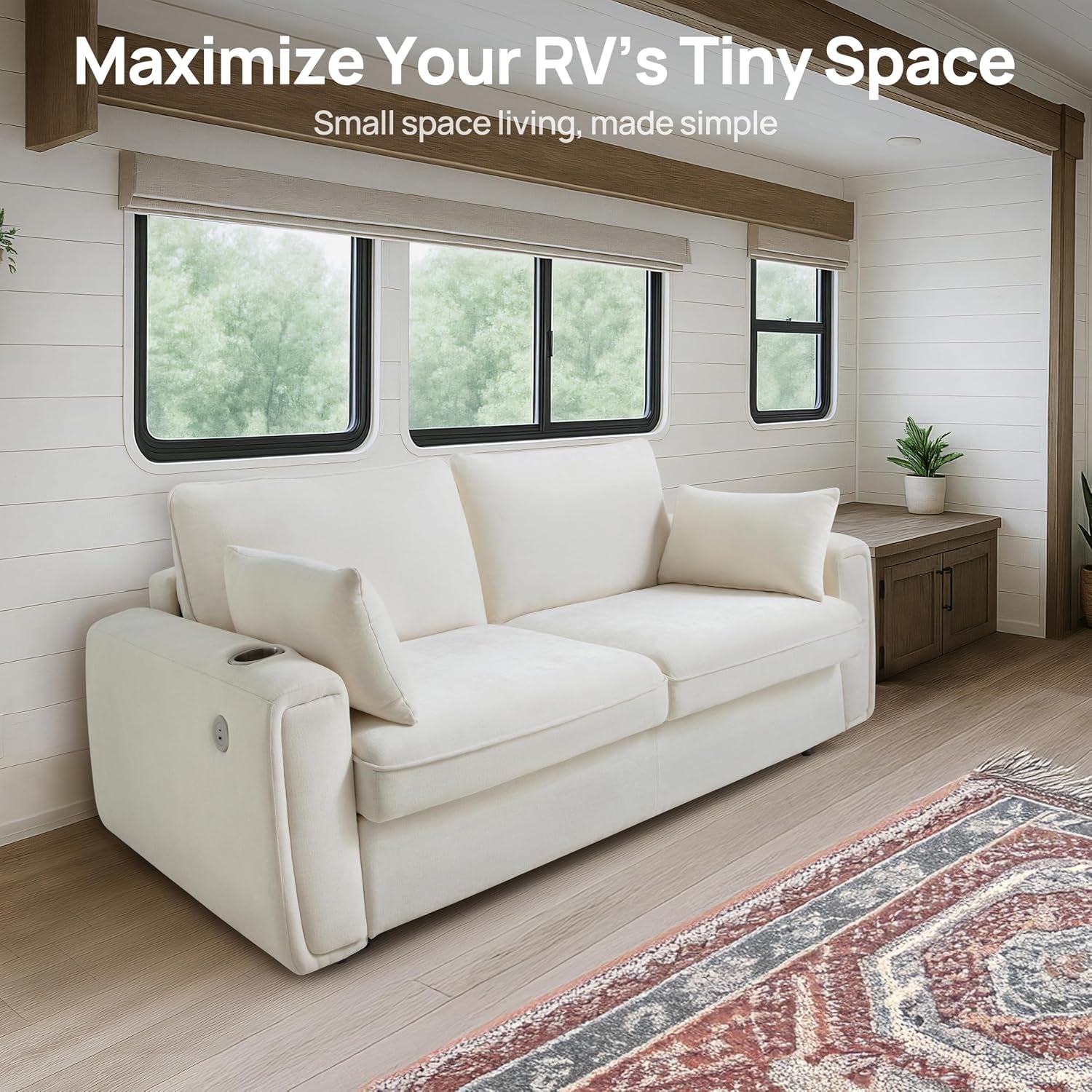 White sofa placed inside an RV under three windows, two back cushions and a side cup holder visible.