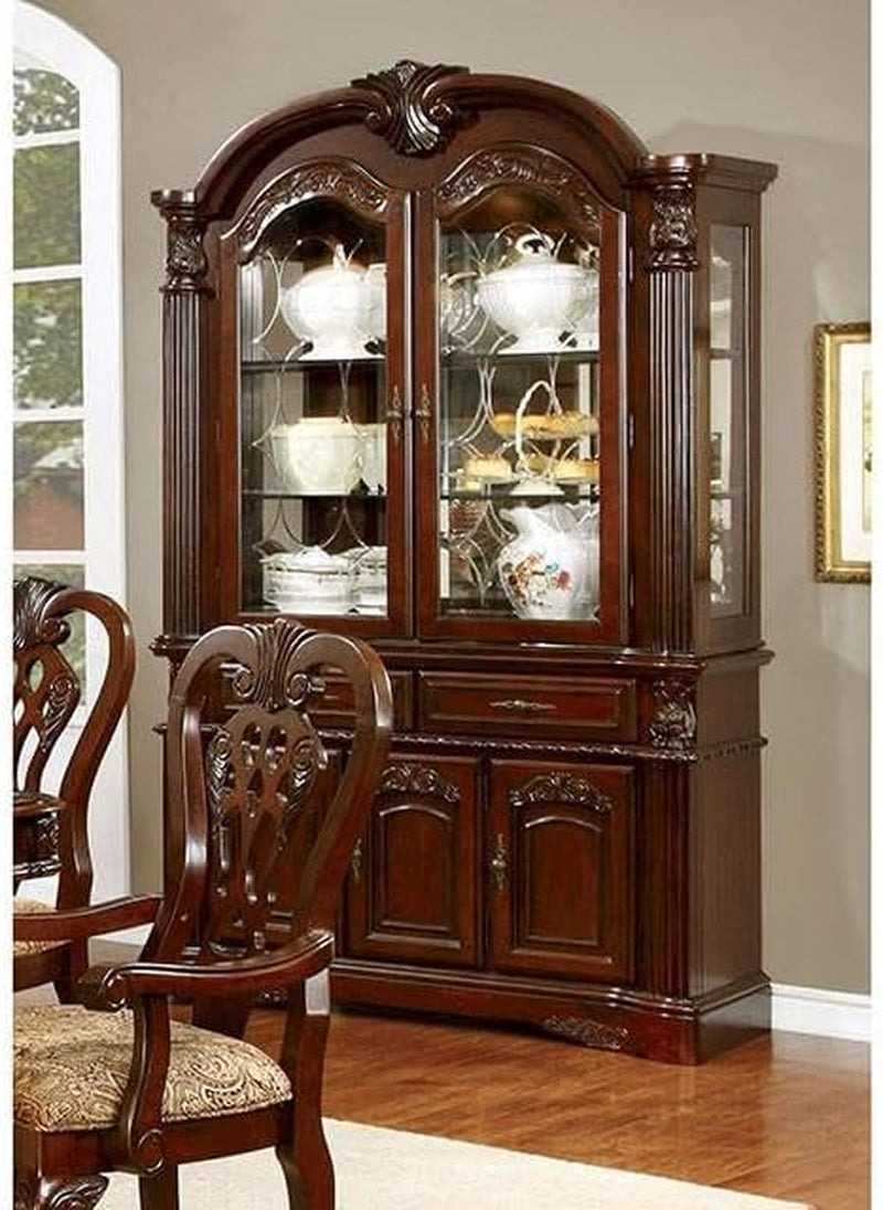Brown cherry hutch and buffet with glass doors and carved arched top, angled front view in a dining room