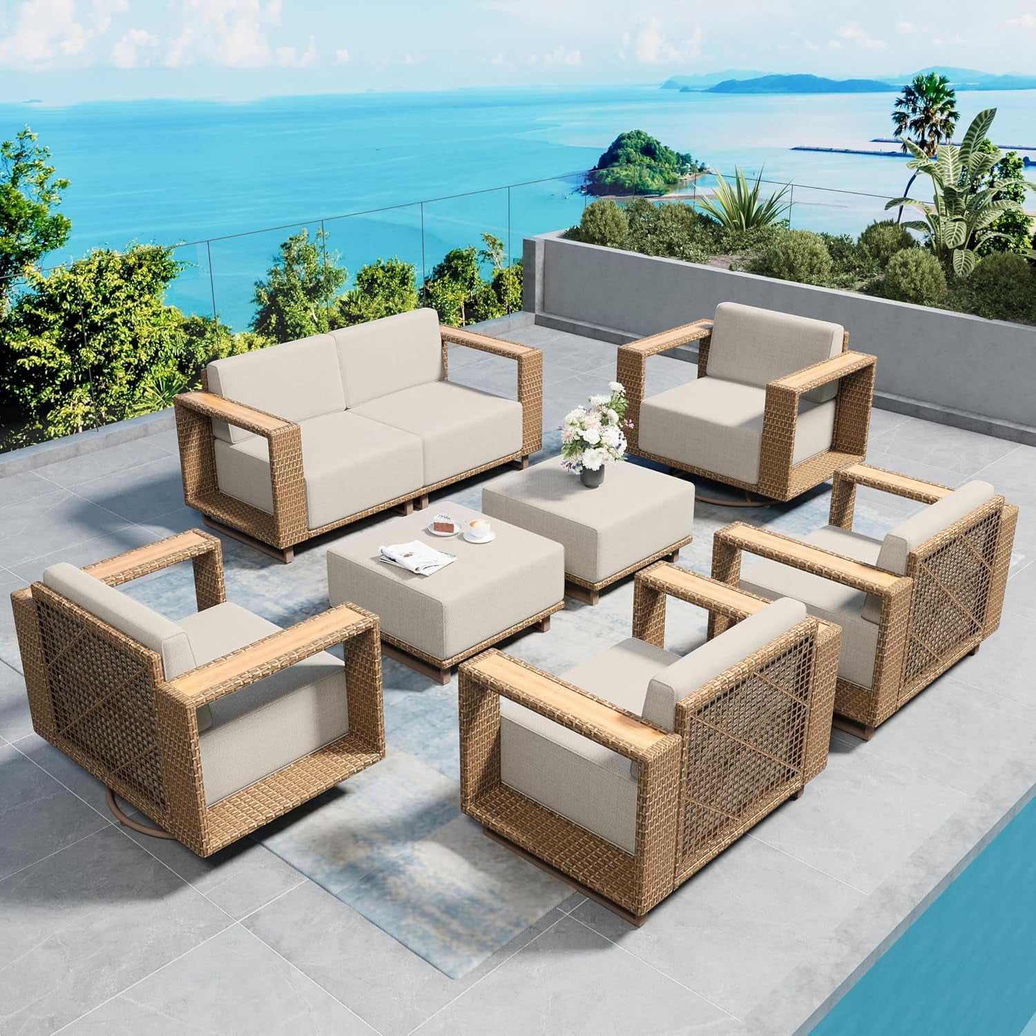 Outdoor patio scene with eight-piece rattan seating: sofa, four armchairs, two ottomans and a coffee table by the ocean.