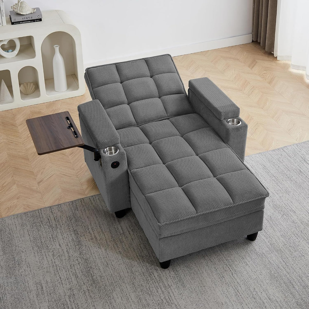 Top-down view of dark-gray chaise showing square tufting, cup holders in both arms and extended tray.