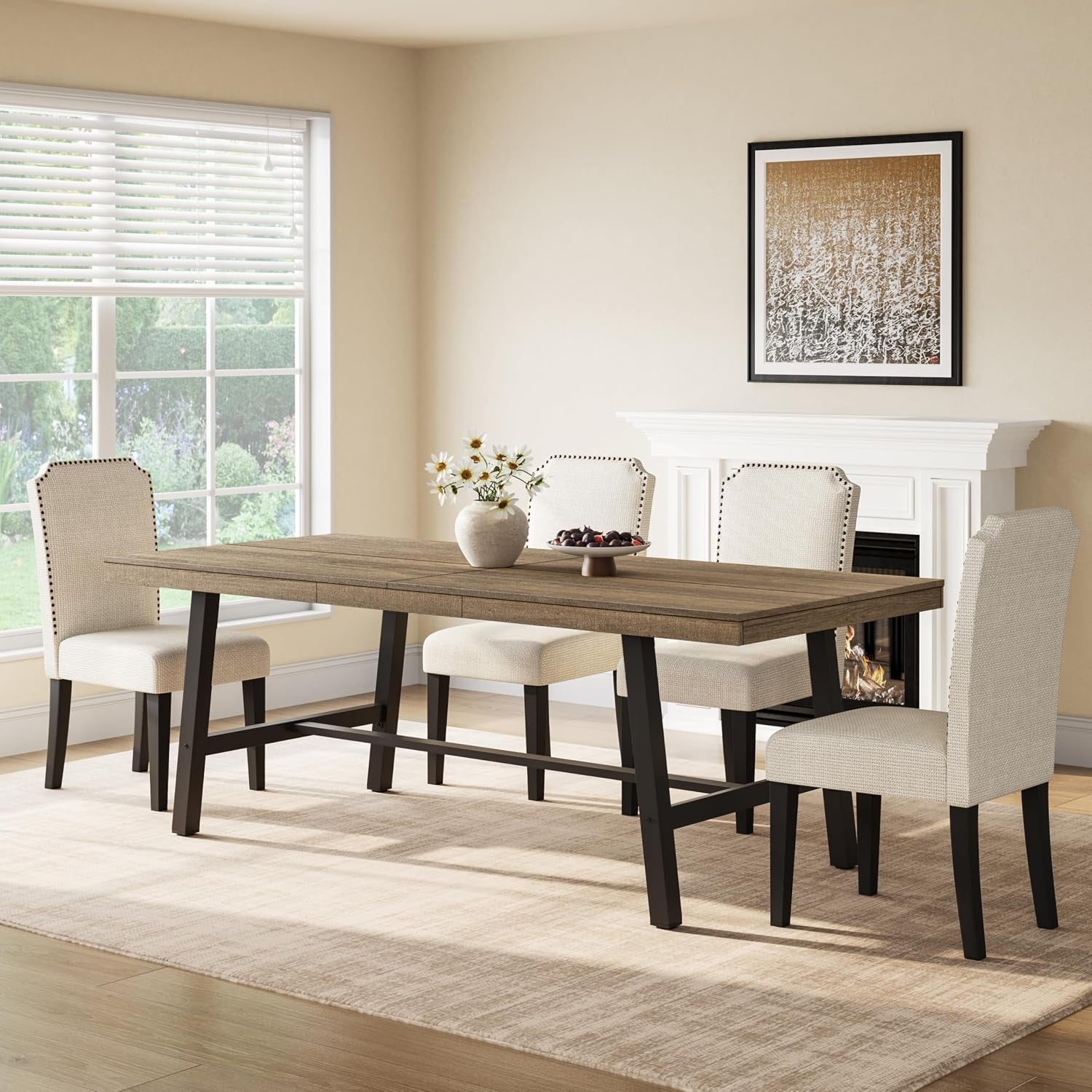 Side view of the long dining table with medium brown wood top, bench-style stretcher and upholstered chairs