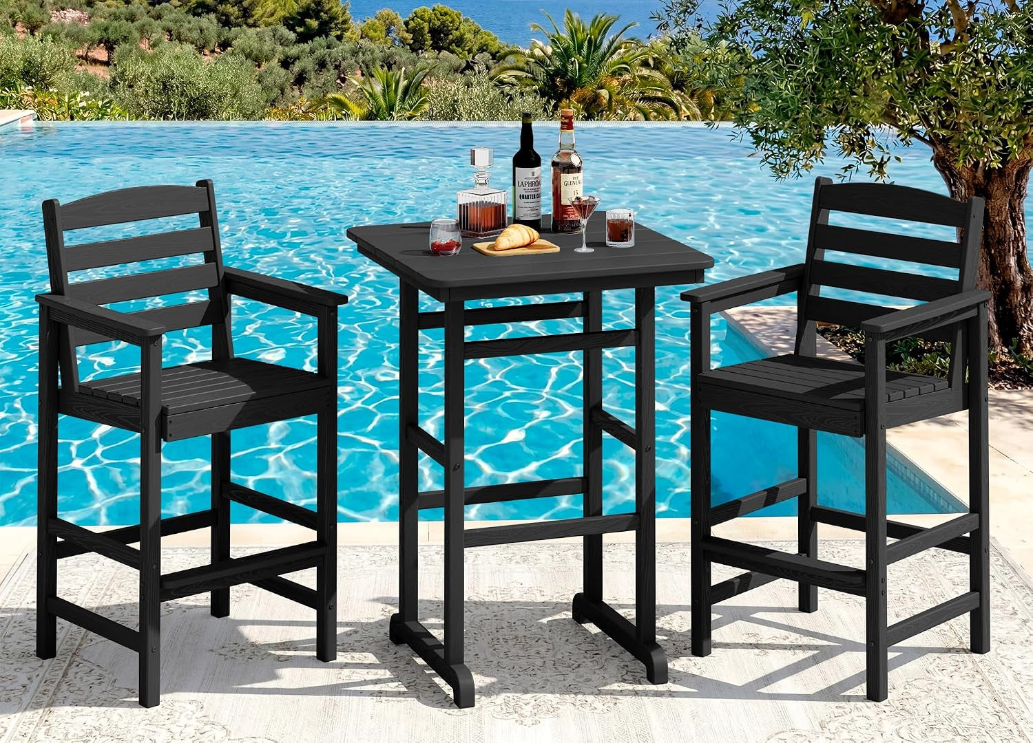 Black bar table with two matching bar chairs set on a light rug beside a pool