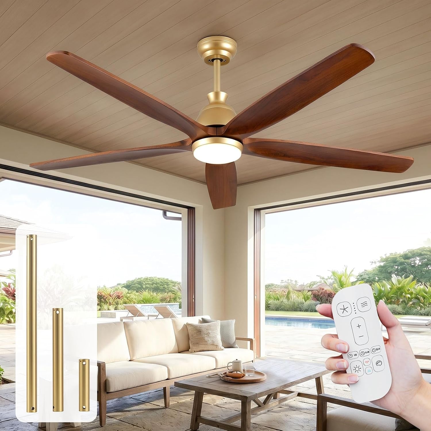 Wide-angle shot of a gold-brass 5-blade ceiling fan over a covered patio; pool and lounge chairs visible outside.