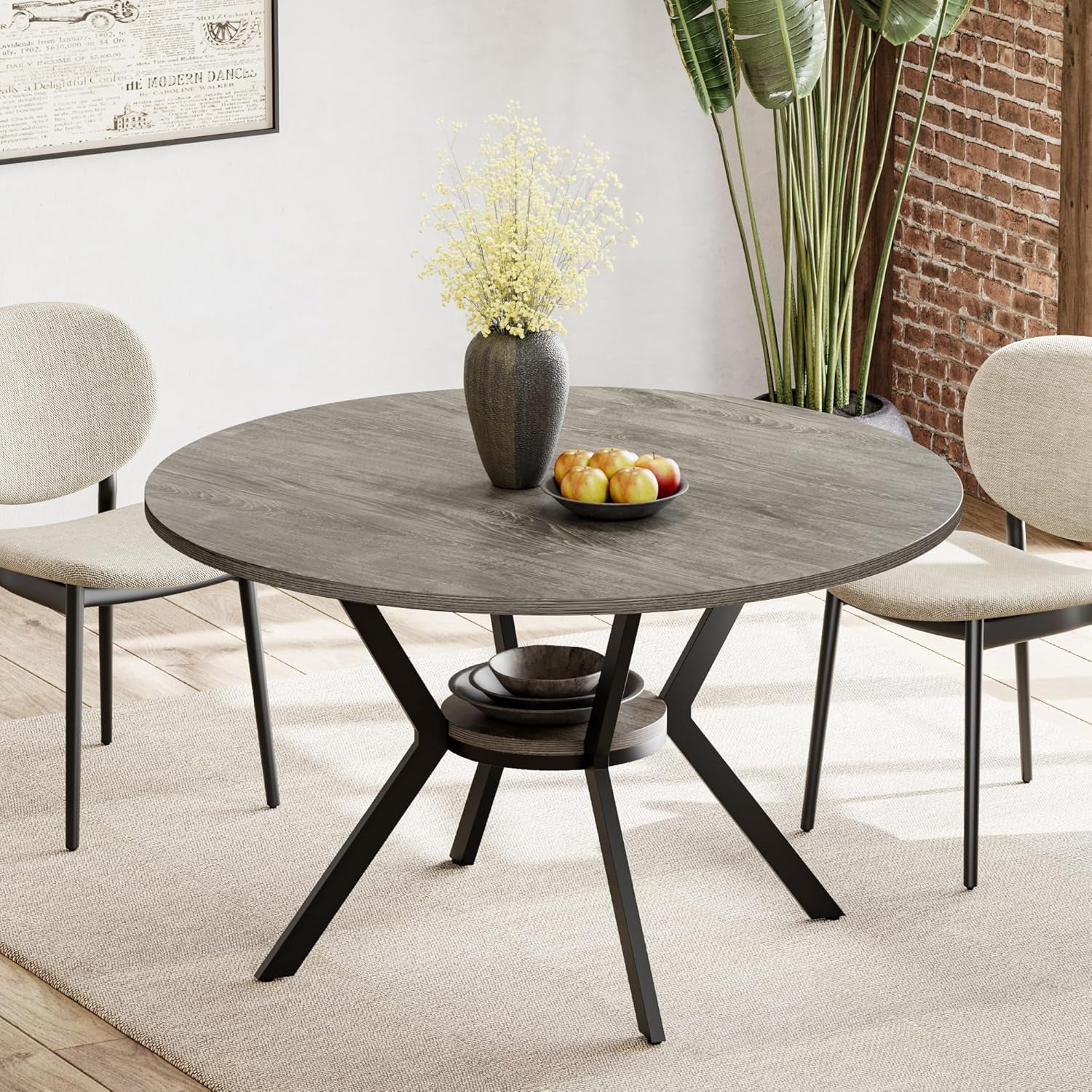 Round gray wood table with black X-base, vase and bowl of apples on a neutral rug