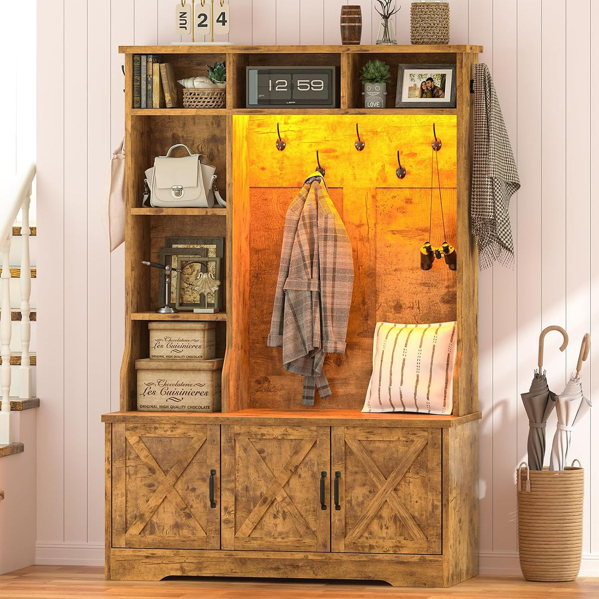 Rustic brown hall tree with open left shelving, bench pillow and umbrella stand at right beside stairs.