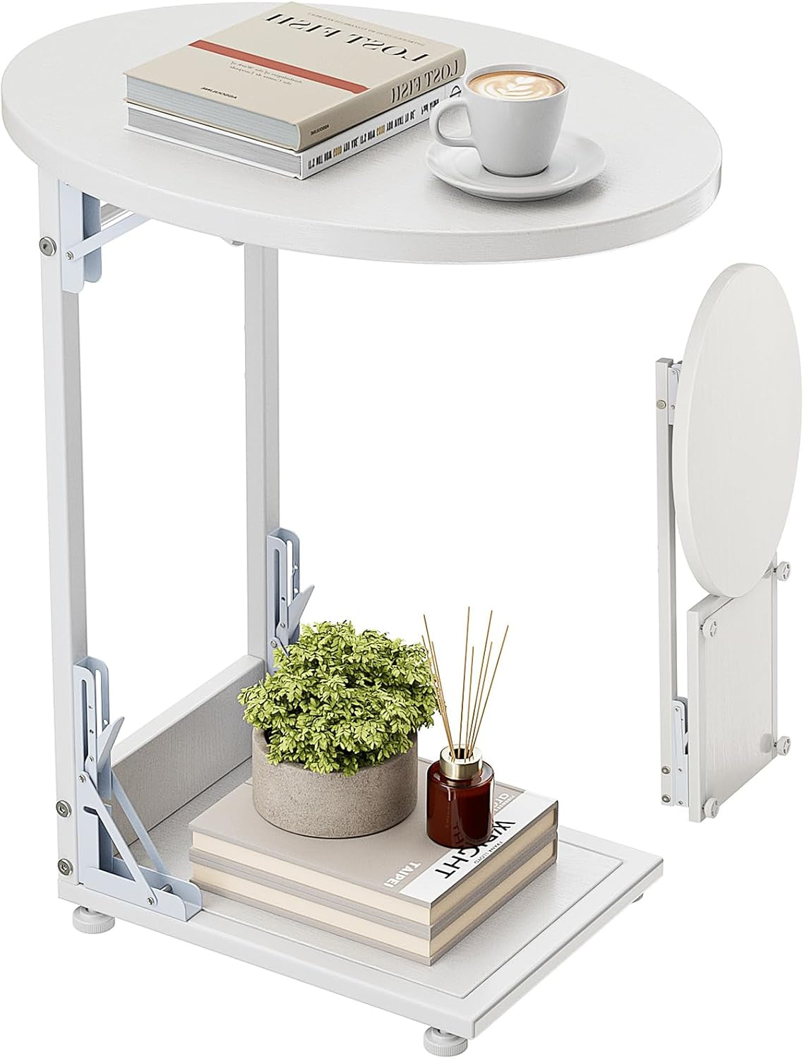 White C-shaped folding end table shown with round top, lower shelf and a stacked book, plant, and cup