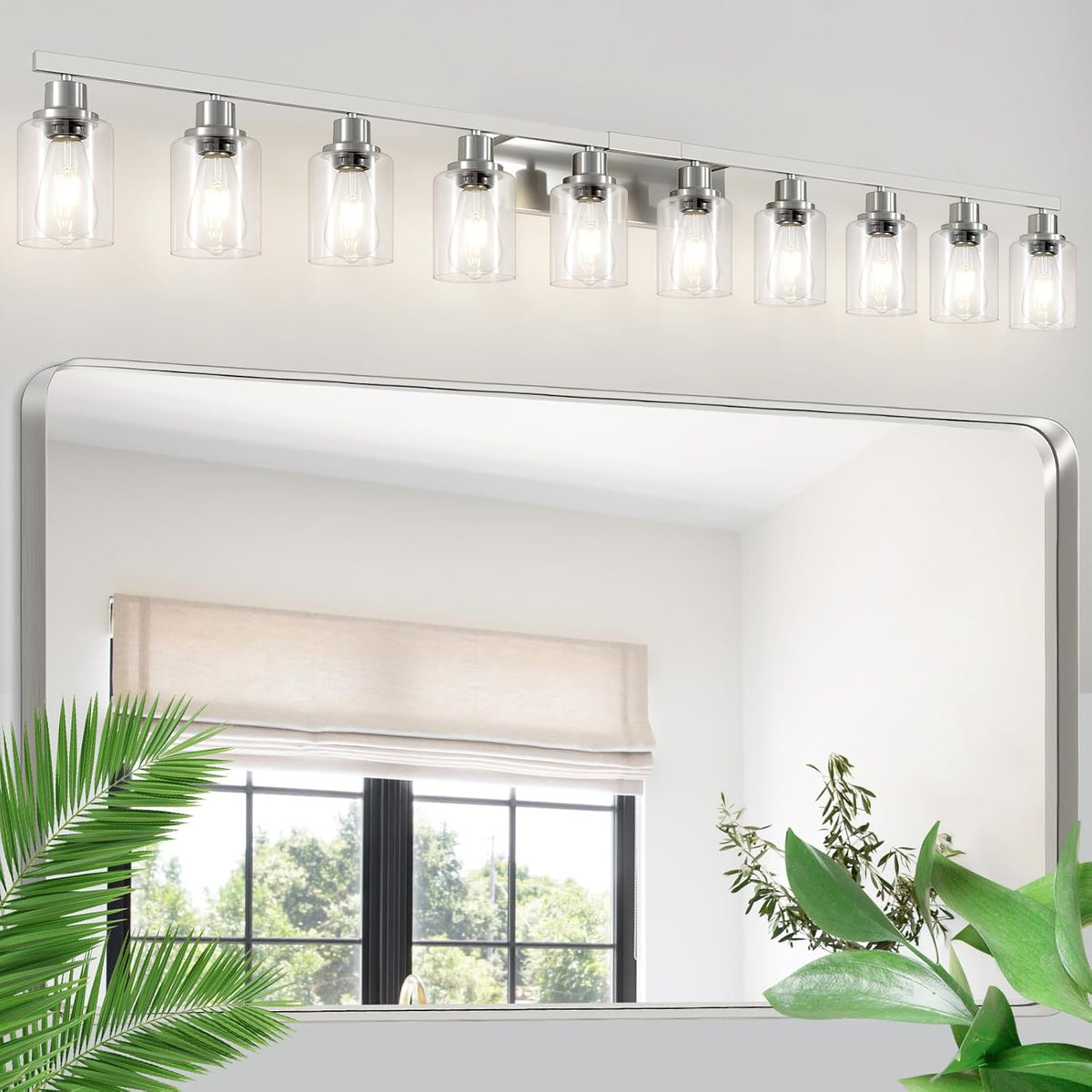 Long silver vanity light with ten clear cylindrical glass shades mounted above a mirror.