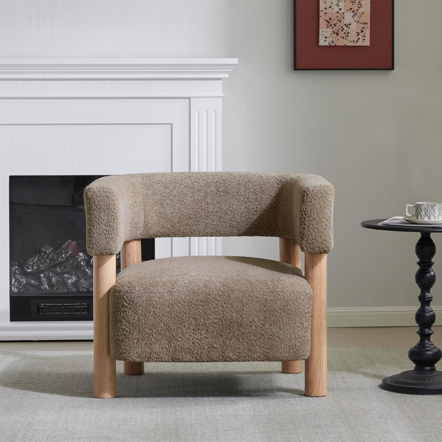 Light camel boucle low-profile accent chair front view in a living room setting with fireplace