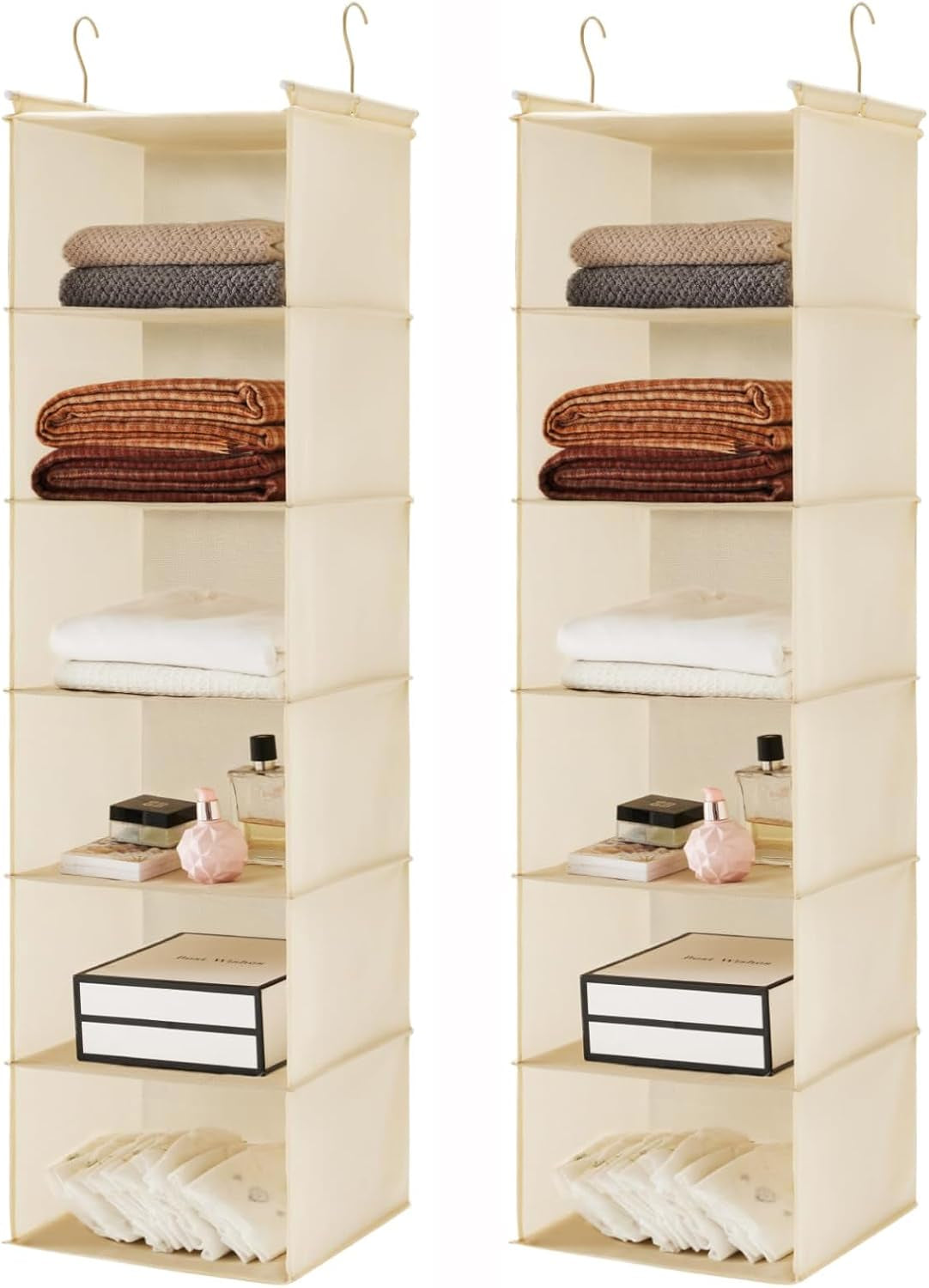 Two beige six-tier hanging organizers side by side, each holding folded clothes and small boxes on the shelves.