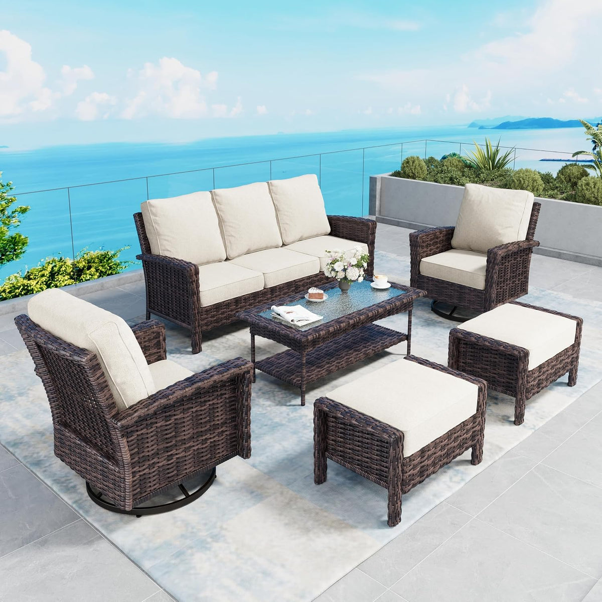 Patio furniture arranged with sofa, swivel chairs and two ottomans with beige cushions
