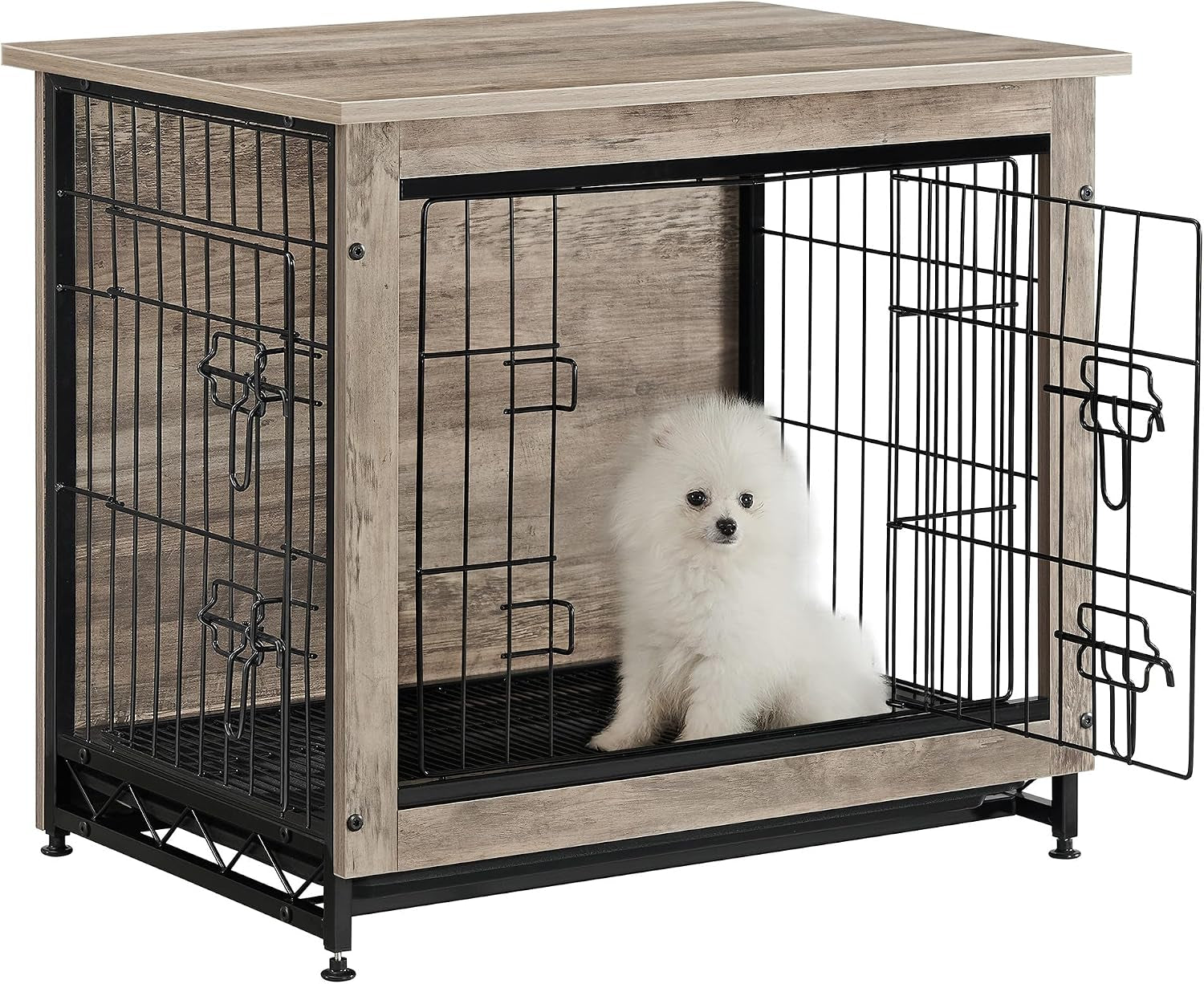 Light greige wood-finish dog crate with open door and a small white fluffy dog sitting inside.