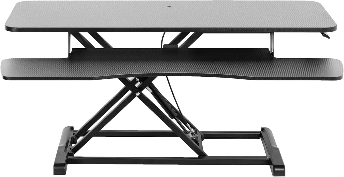 Front view of a black textured standing desk converter with scissor lift and keyboard shelf