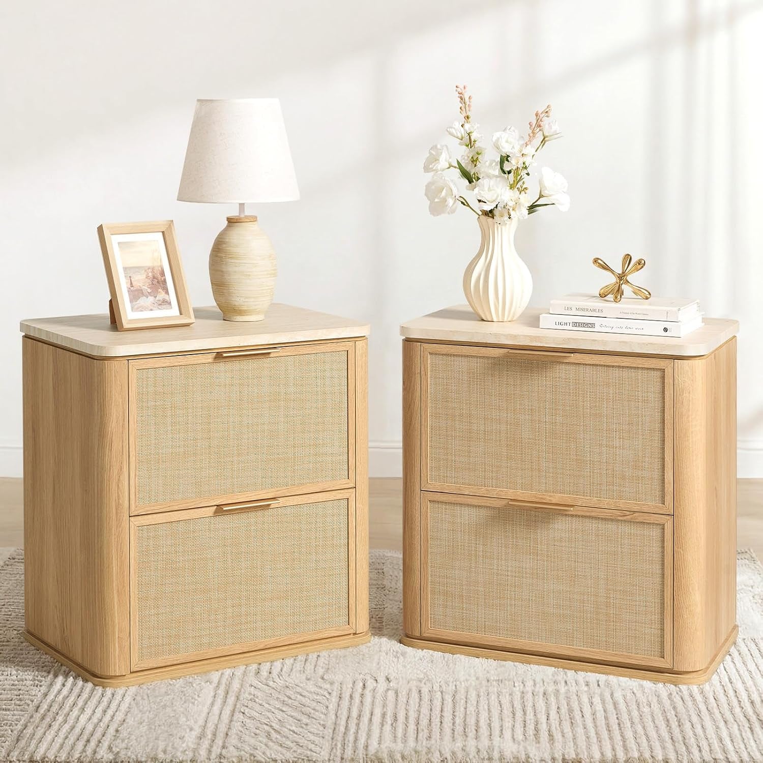 Pair of natural oak rattan-look nightstands with faux travertine tops styled with lamp and vase