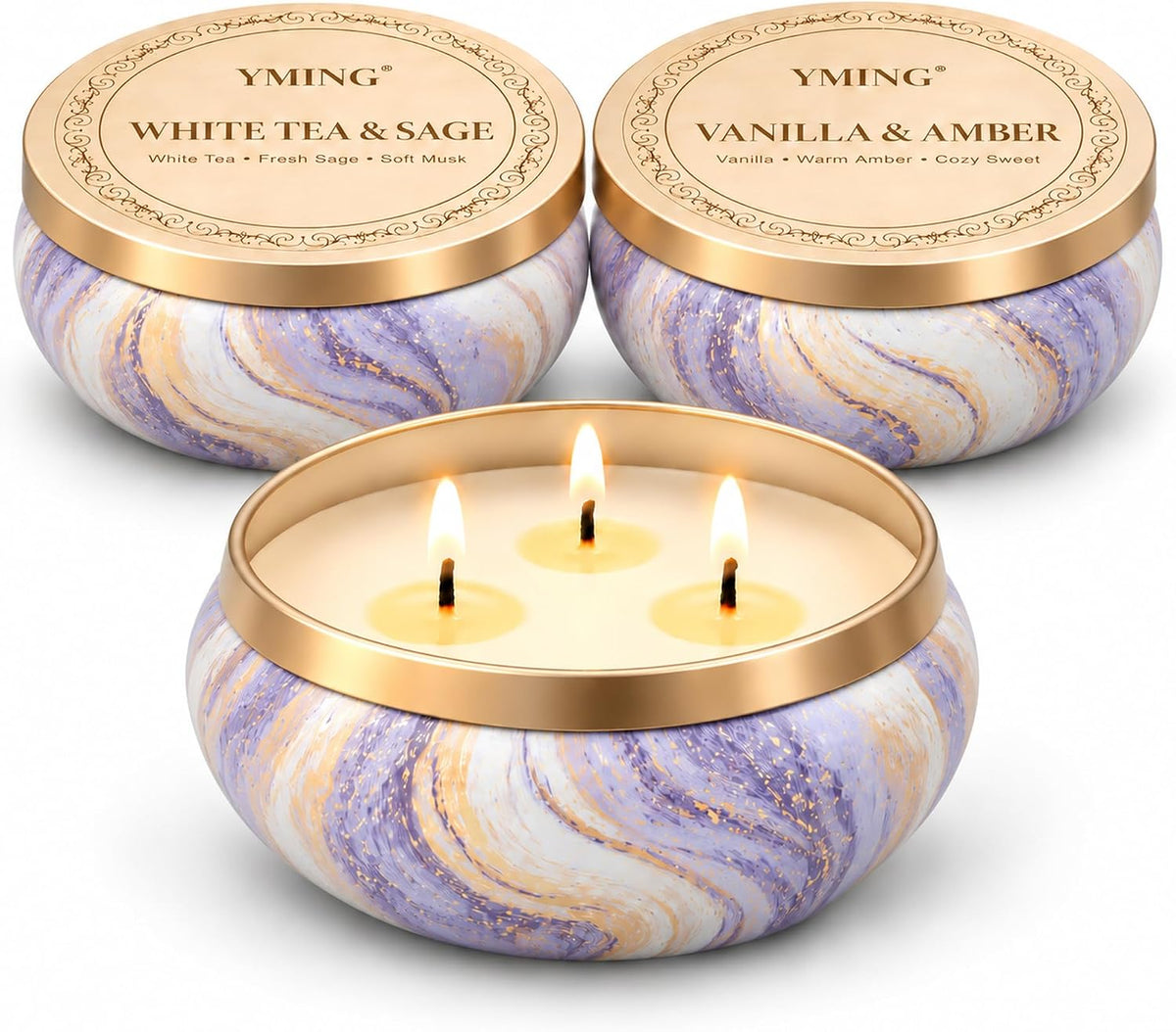 Close-up of three marbled tins with gold lids, foreground candle burning with three wicks visible
