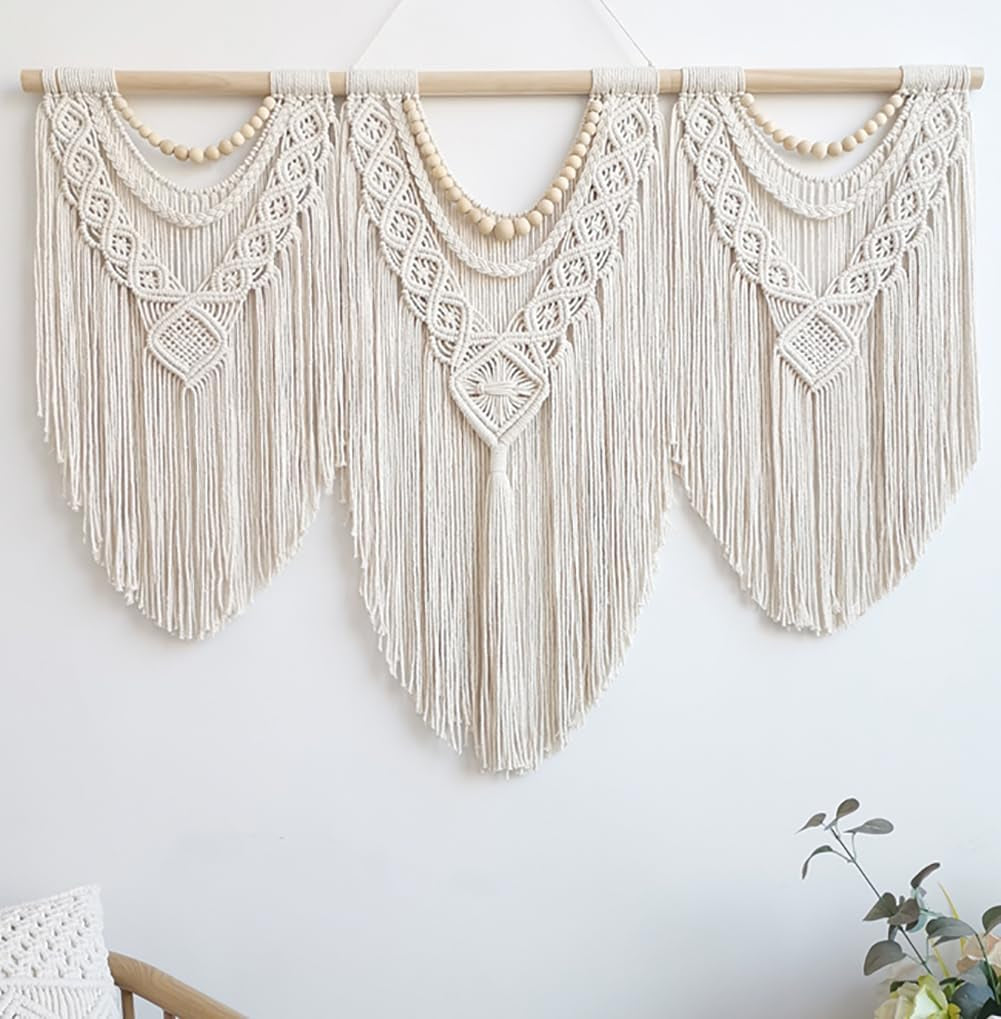 Front view of ivory knotted macrame hanging with three fringed panels