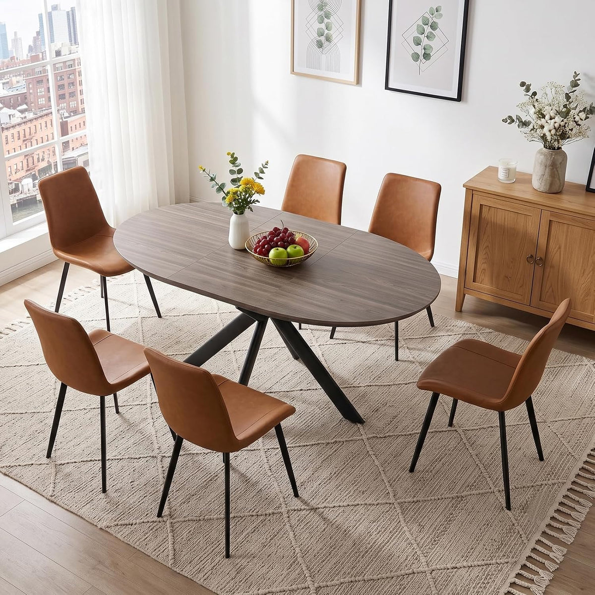 Oval wood dining table with six caramel-brown PU chairs around it in a bright room
