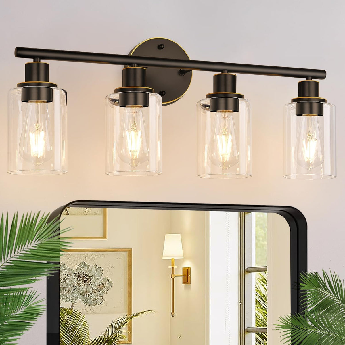 Four-light black vanity fixture with thin gold accent rings, clear cylindrical shades and lit filament bulbs.