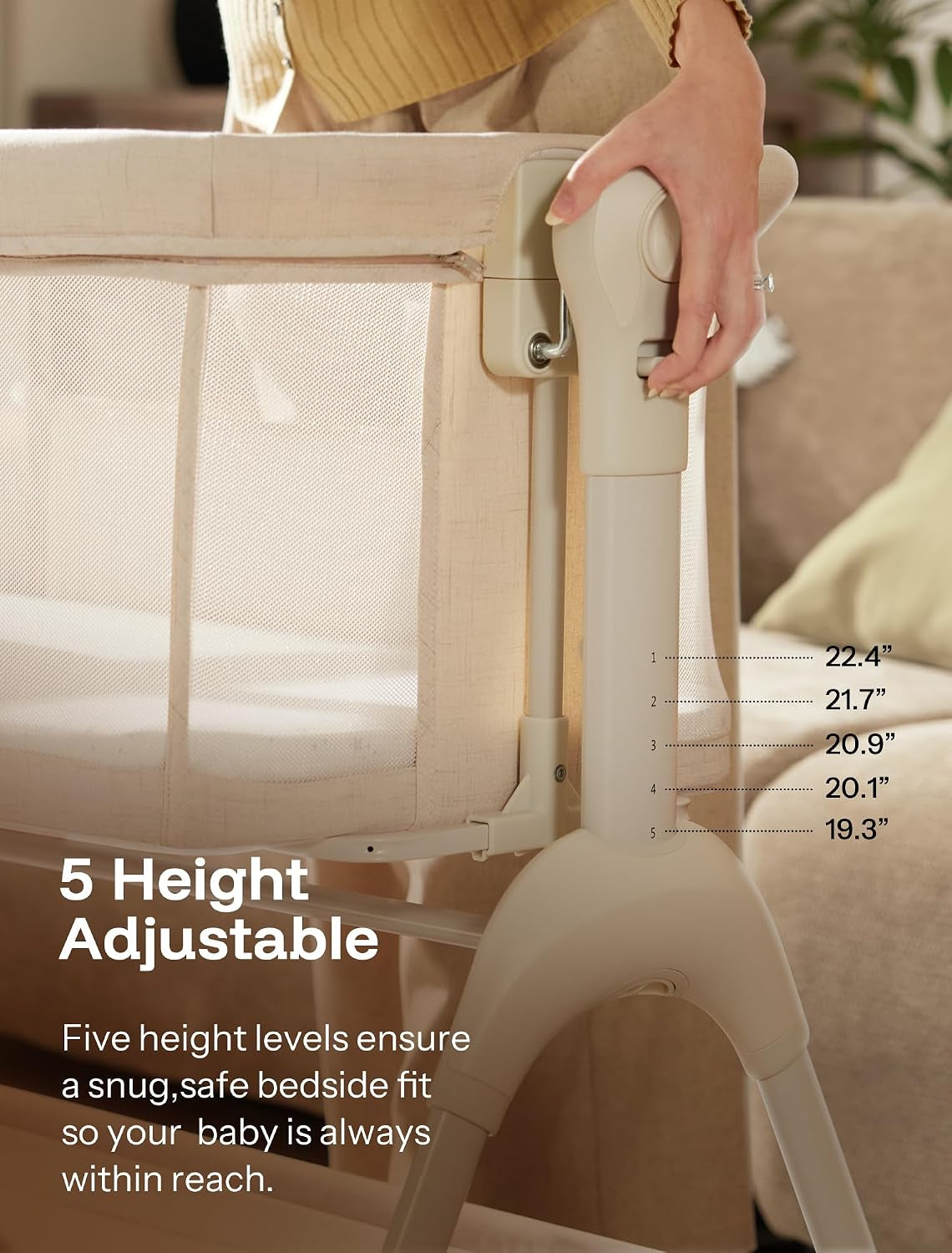 Close-up side view of the bassinet leg and mesh side with a hand adjusting the height mechanism.