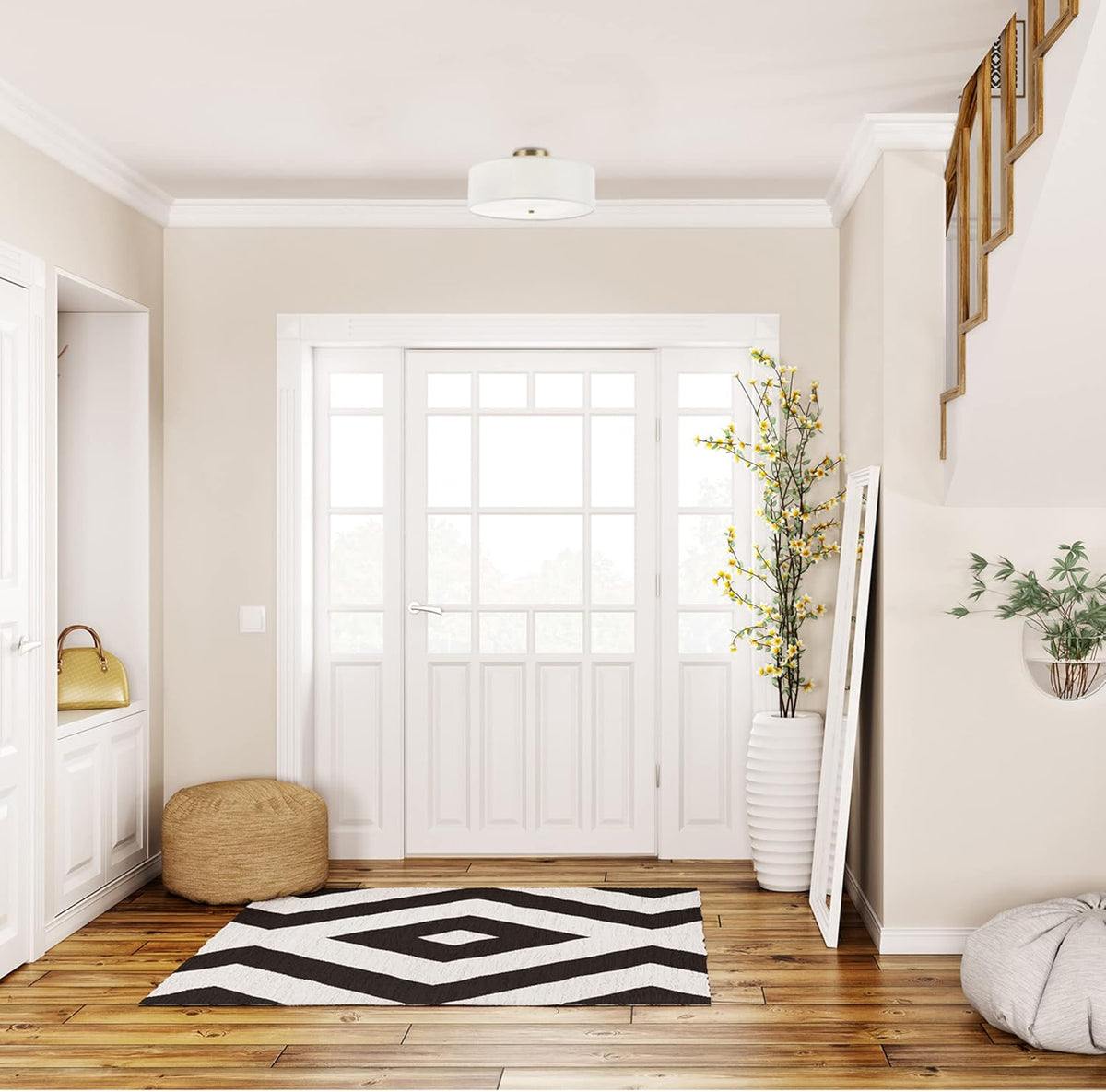 White fabric drum flush mount centered in an entryway ceiling above a front door