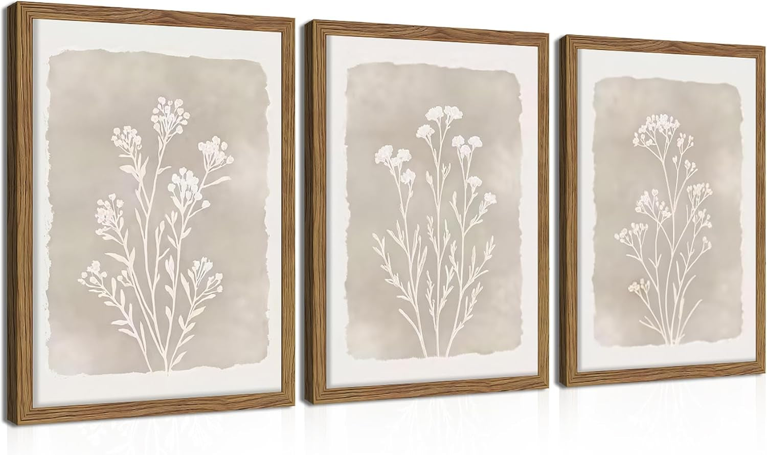 Three framed prints shown on a plain white background featuring beige watercolor panels with white botanical silhouettes.