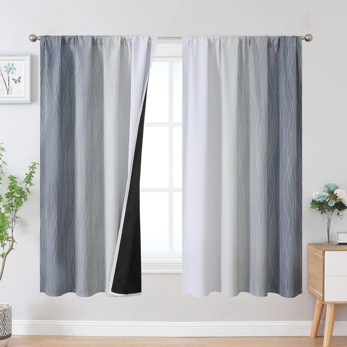 Window framed by light-to-medium gray ombre curtains with subtle white wave lines and visible black blackout liner