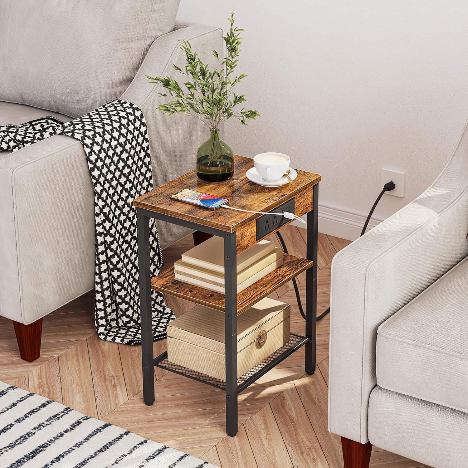 Rustic brown side table next to a sofa with phone charging on top and storage on middle and bottom shelves