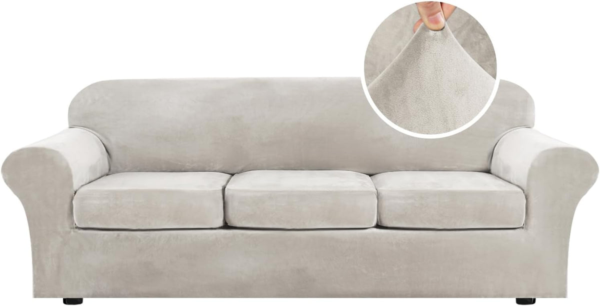 Front view of a three-seat sofa covered in a light gray/ivory stretch velvet slipcover with a round fabric texture close-up.