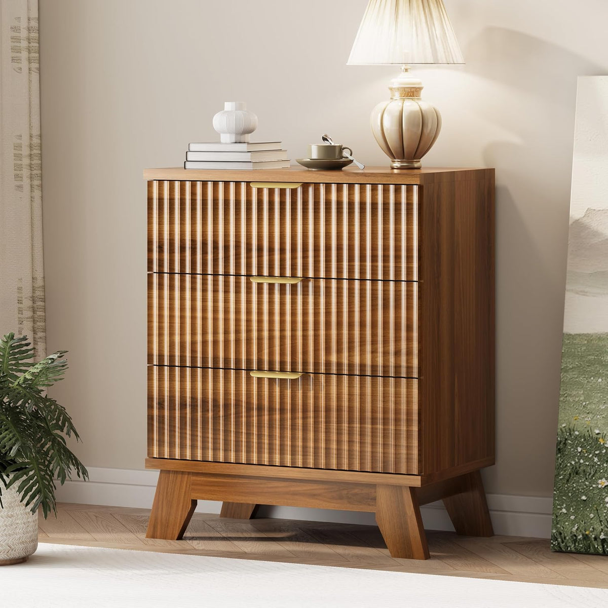Close three-quarter view of a wood-finish tall chest showing ribbed drawer fronts, angled legs and a lamp on top.