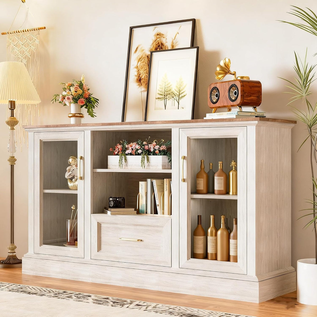 Angled room view of the TV stand top with framed art and decorative objects on the wood-grain tabletop