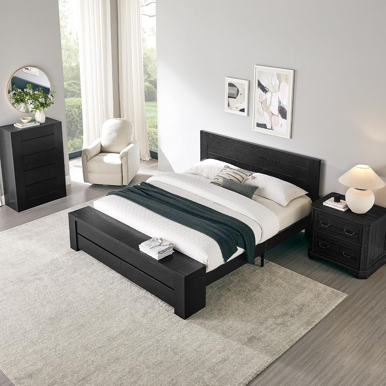 Styled bedroom showing the bed with headboard and storage bench at the foot in a bright, modern room.
