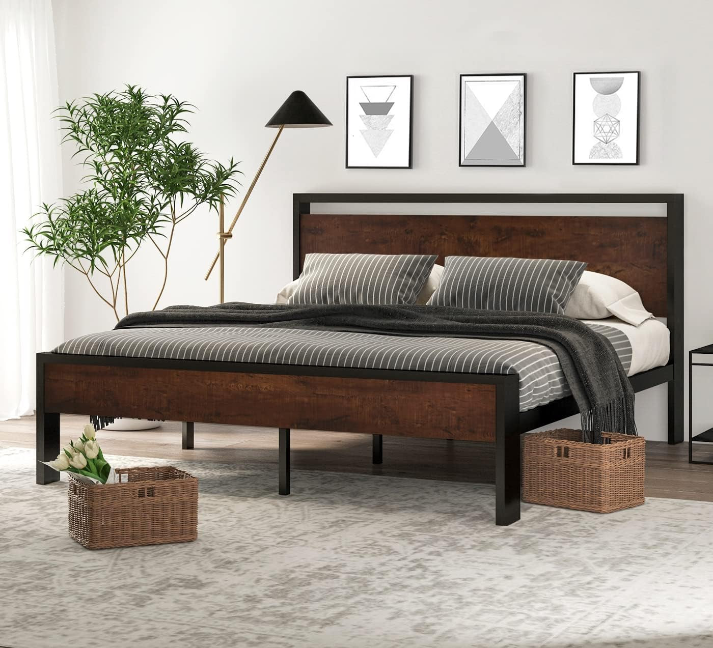 Platform bed in brown wood finish with black metal frame shown angled in a styled bedroom