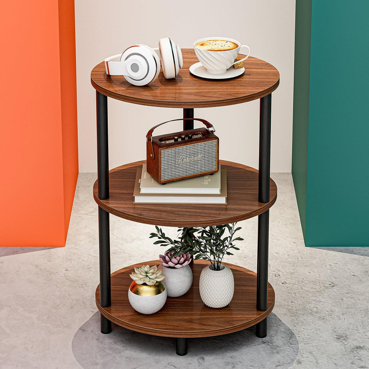 Round three-tier wood-finish end table with black metal legs staged with headphones, coffee and a small radio.