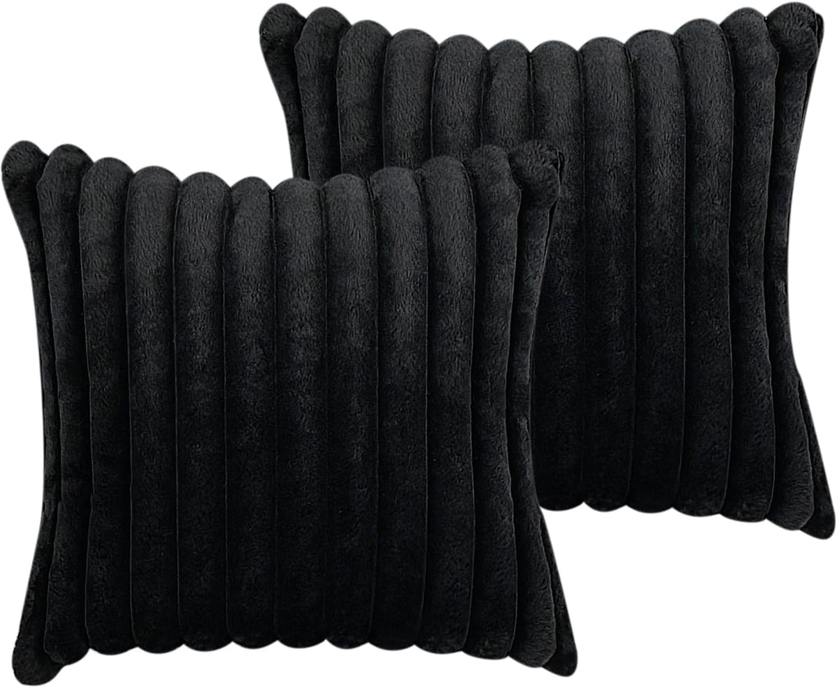Pair of black square pillow covers shown close-up with plush vertical ribbed texture